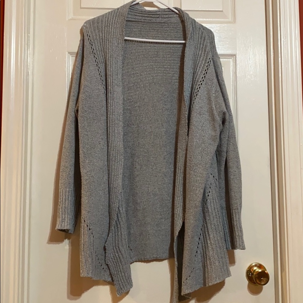 Light blue/gray cardigan.